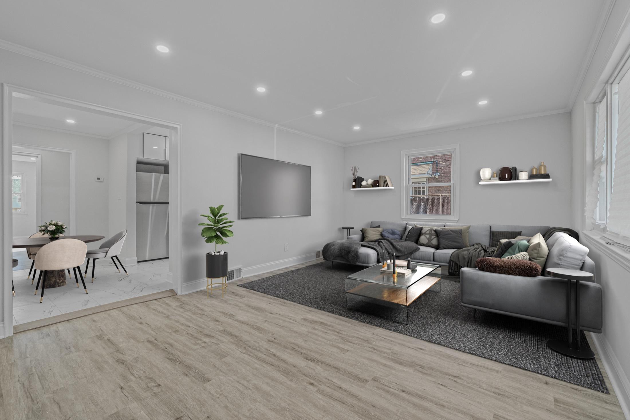 Virtually staged modern living room with a gray sectional